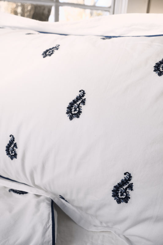 Close-up of the Blue Paisley Embroidered duvet showing the raised navy paisley embroidery and piping