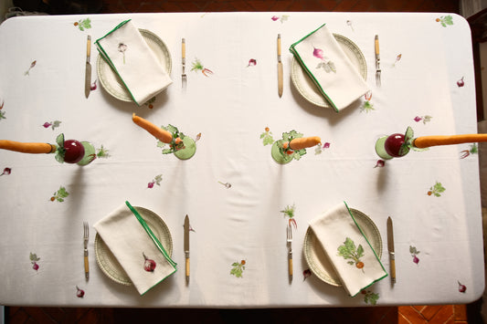 Overhead view of the Root Vegetable Tablecloth set for four, with carrot and beet candlesticks
