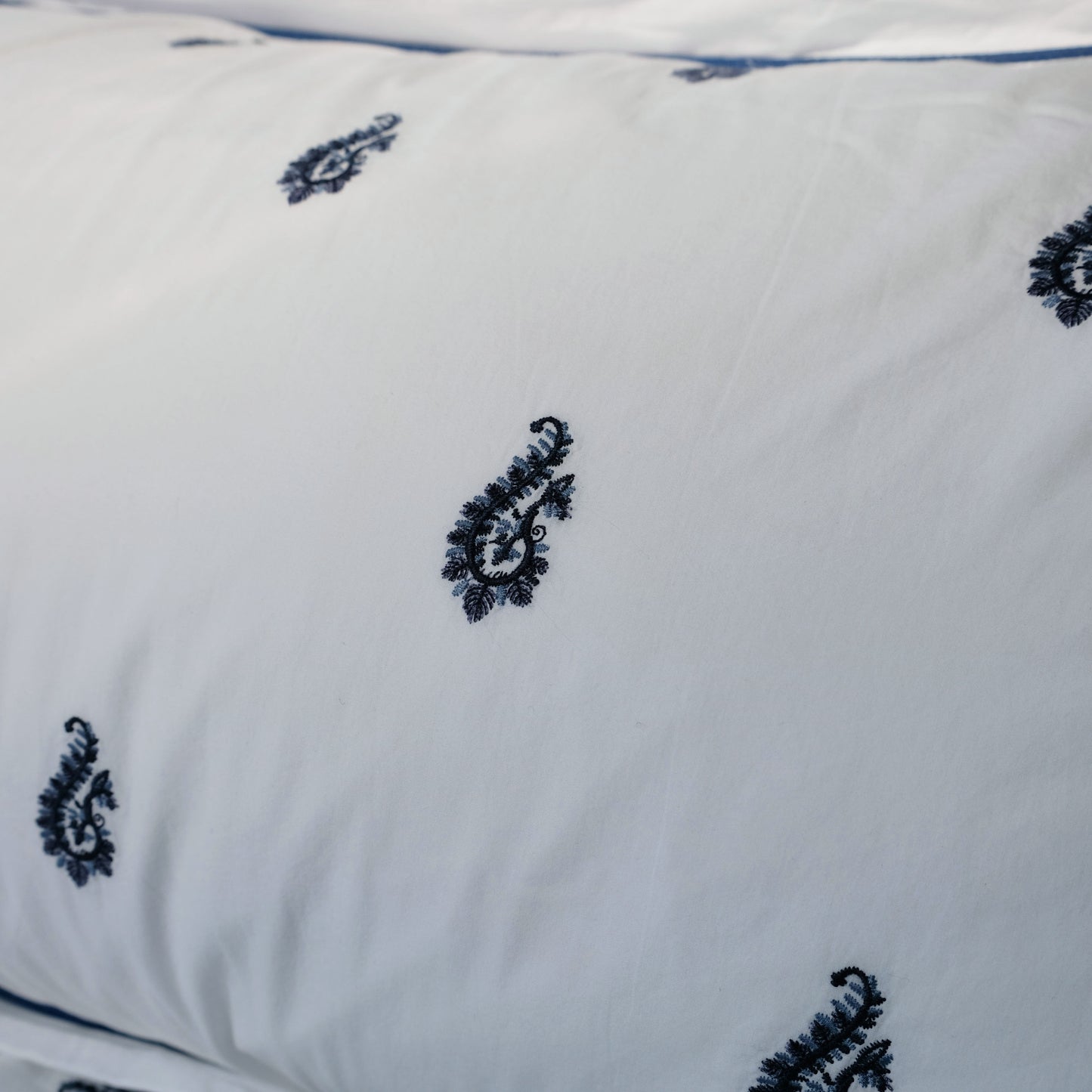 Close-up of Blue Paisley embroidered duvet corner showing stitch detail