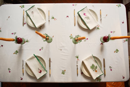 Overhead view of the Root Vegetable Tablecloth set for four, with carrot and beet candlesticks