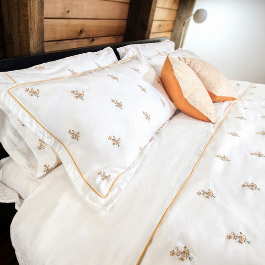Fields of Gold pillowcase detail with hand-drawn yellow flowers