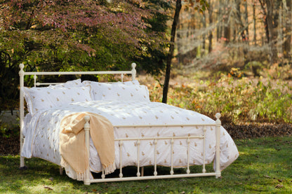Fields of Gold duvet and shams close-up showing yellow floral print and piping