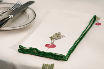 Close-up of the radish print napkin from the Spring Vegetable Napkins set, with its green overlock hem